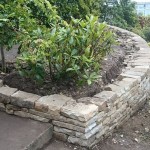 Curved dry stone retaining wall