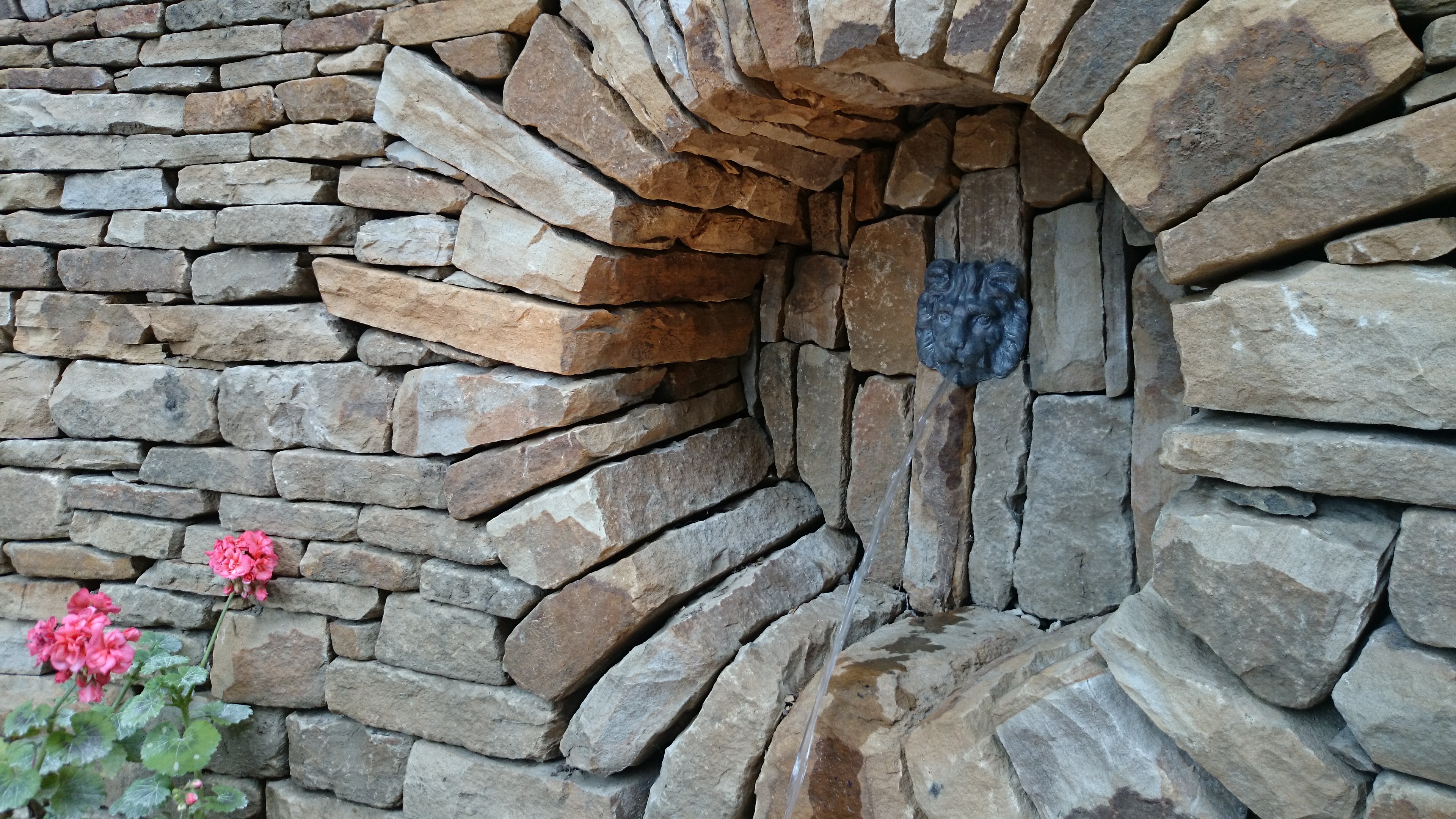 Dry stone moongate and water feature