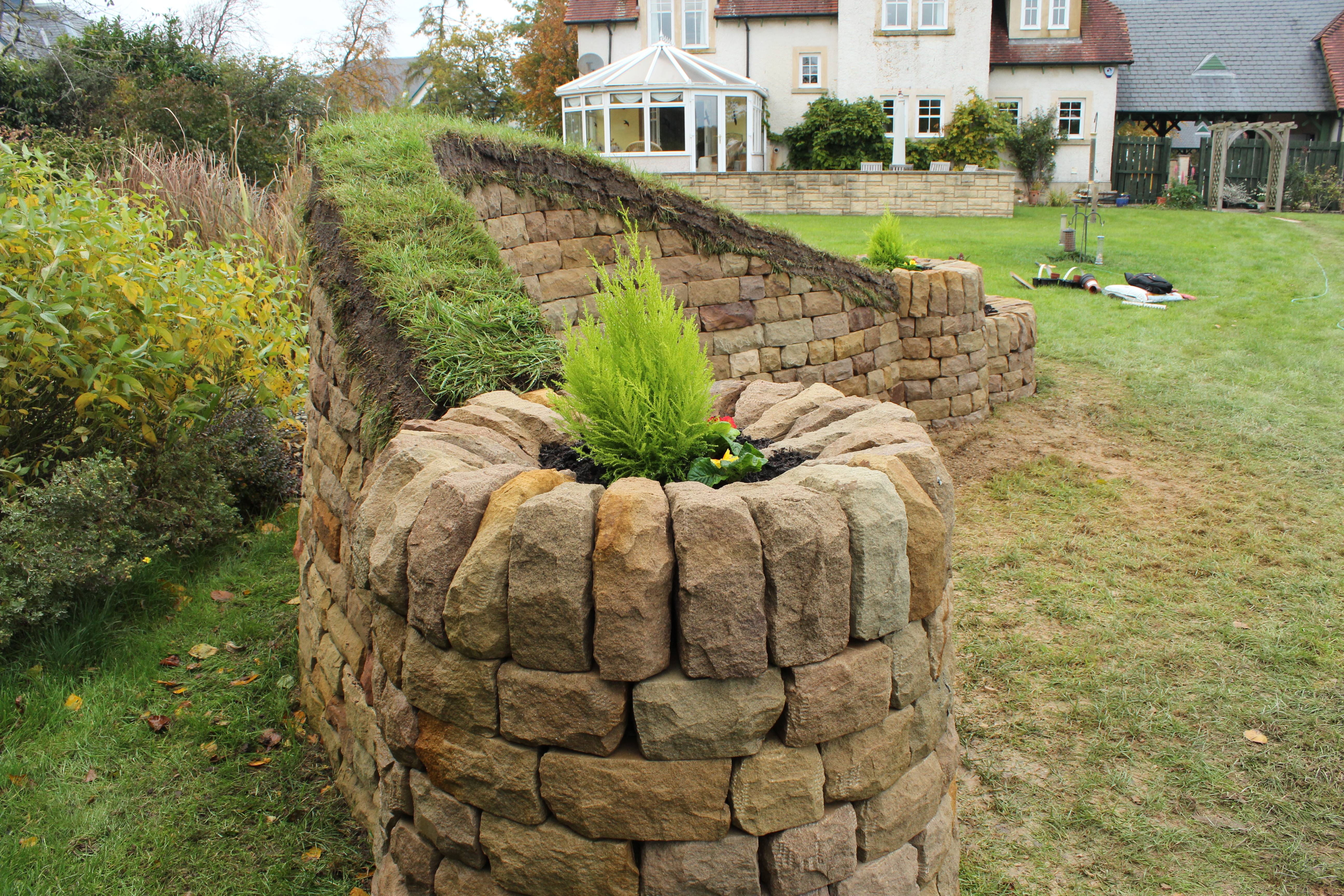 Dry stone bench with wood and turf