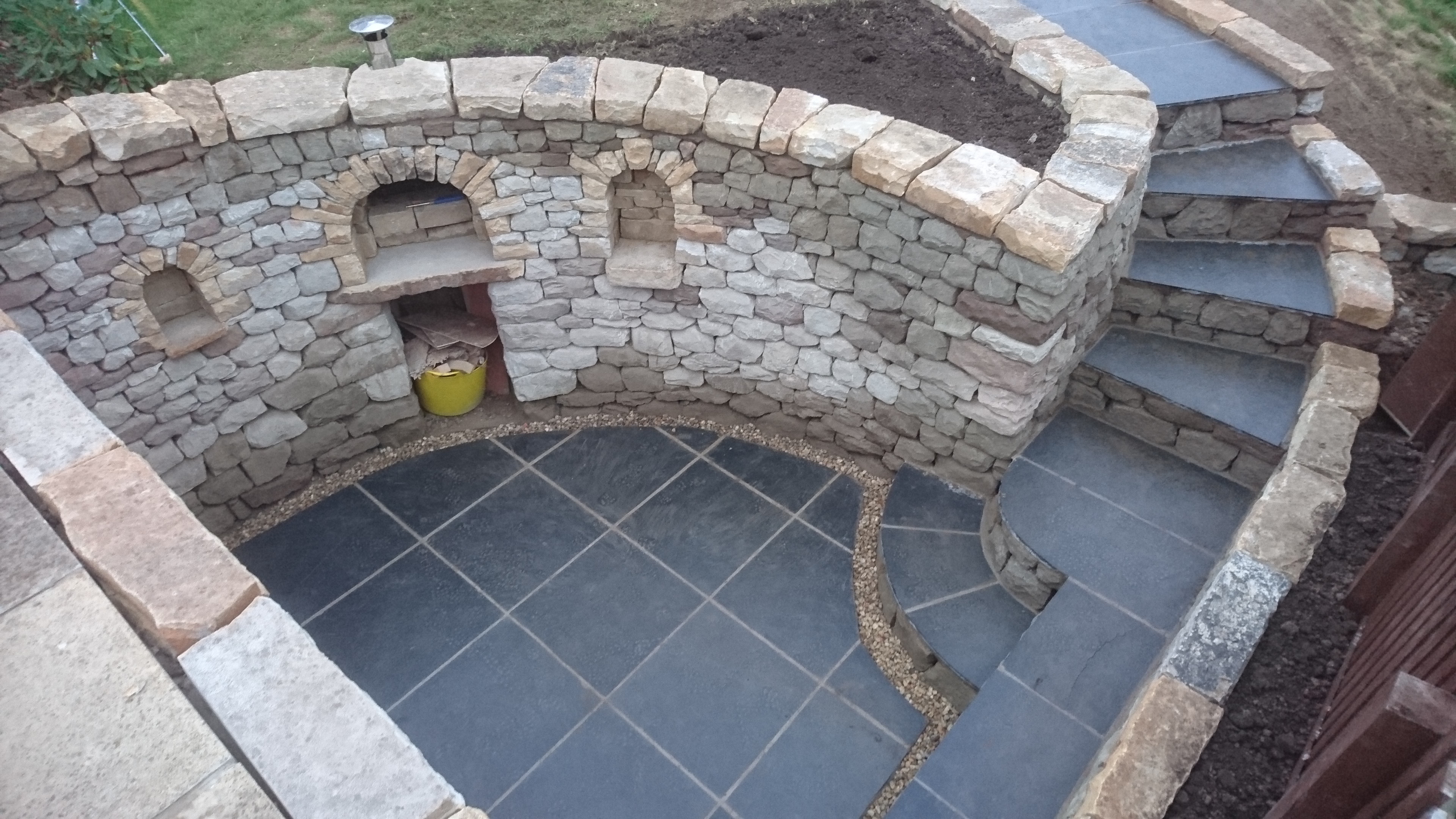 Dry stone seating space and pizza oven