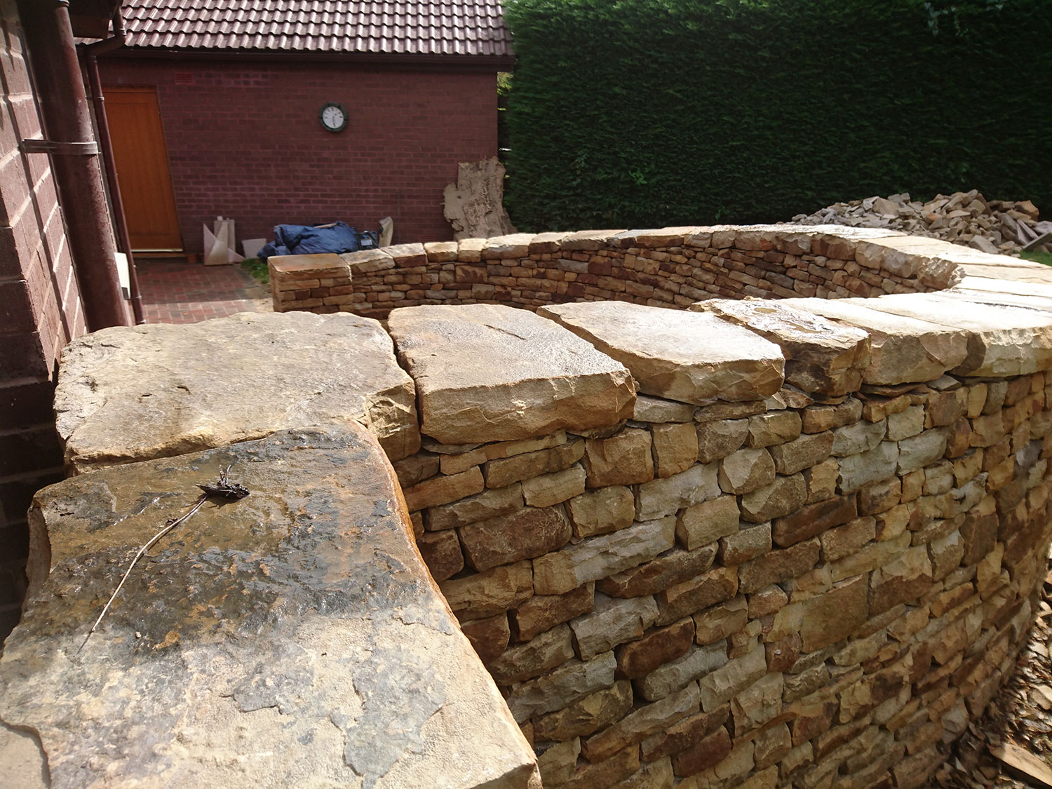 Dry stone bench and paving with large cap stone