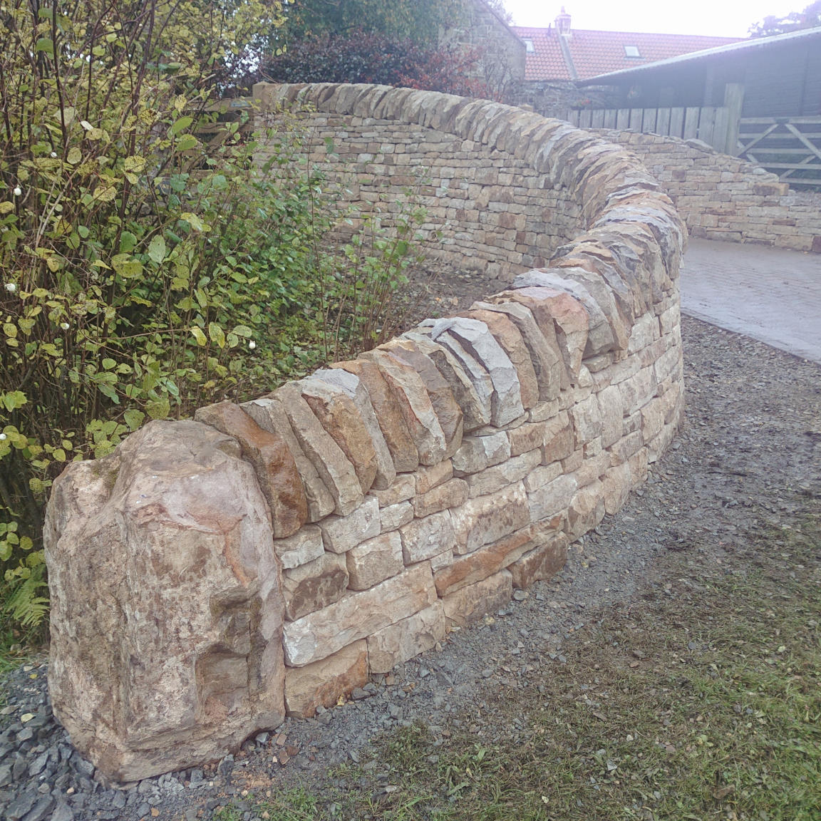 Stone Inspired Curved drystone Entrance wall Stone Inspired