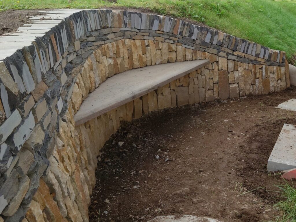 Dry stone bench with pine seat
